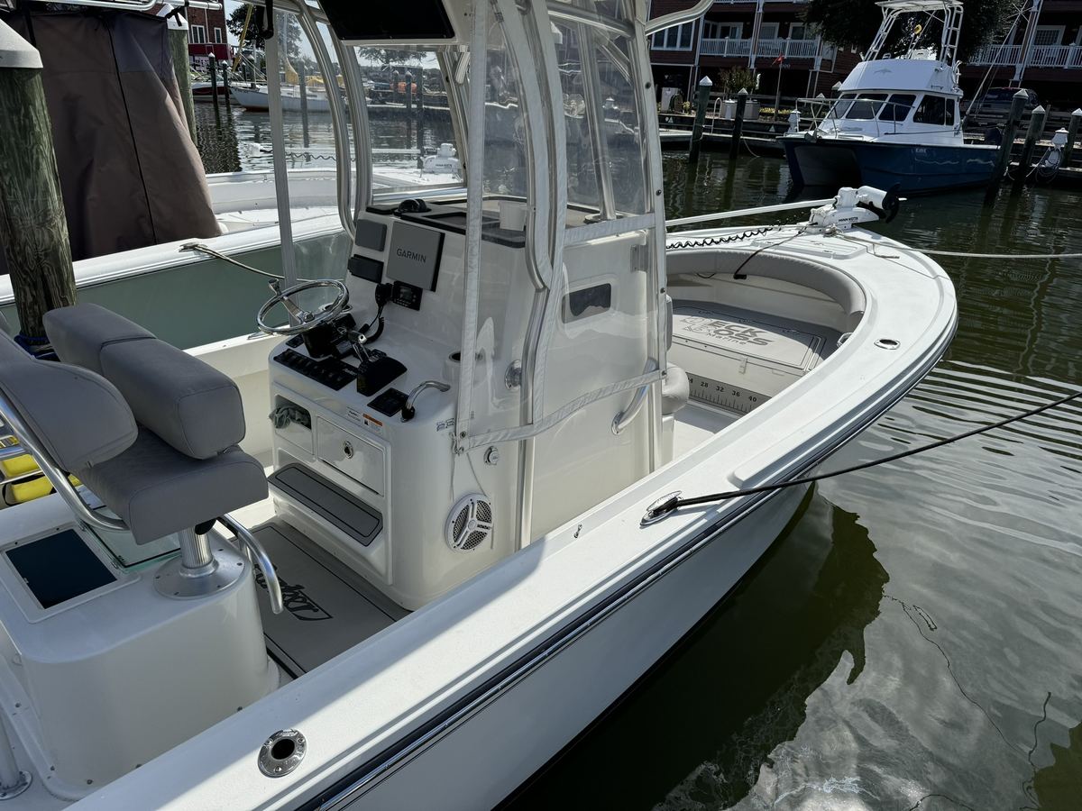 Center console boat at a marina with gray EVA foam decking, fish ruler and Deck Boss Marine logo